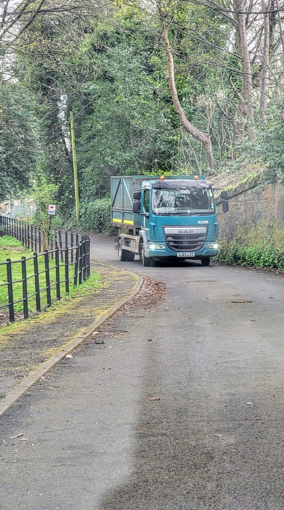 Council truck delivering waste cage up the allotment lane